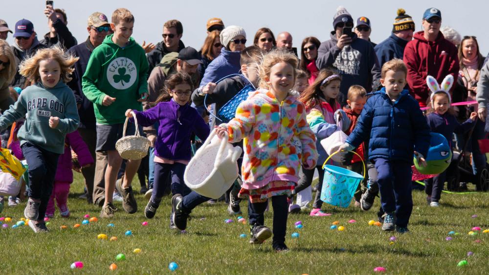 Children run forward to collect eggs at the Mattapoisett Lions Club Easter egg hunt at Neds Point in April. Photo by Sawyer Smook-Pollitt